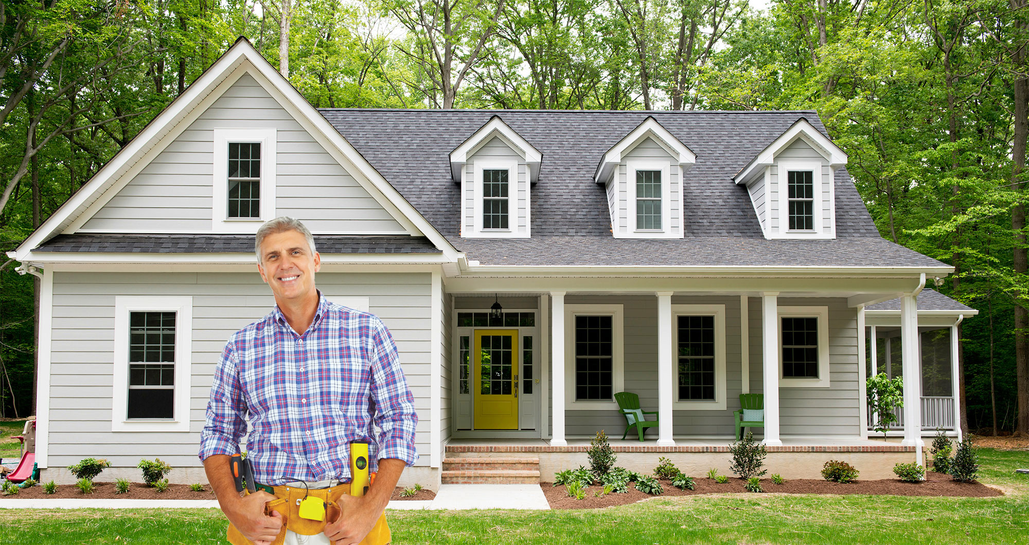 happy contractor standing outside cape style house 