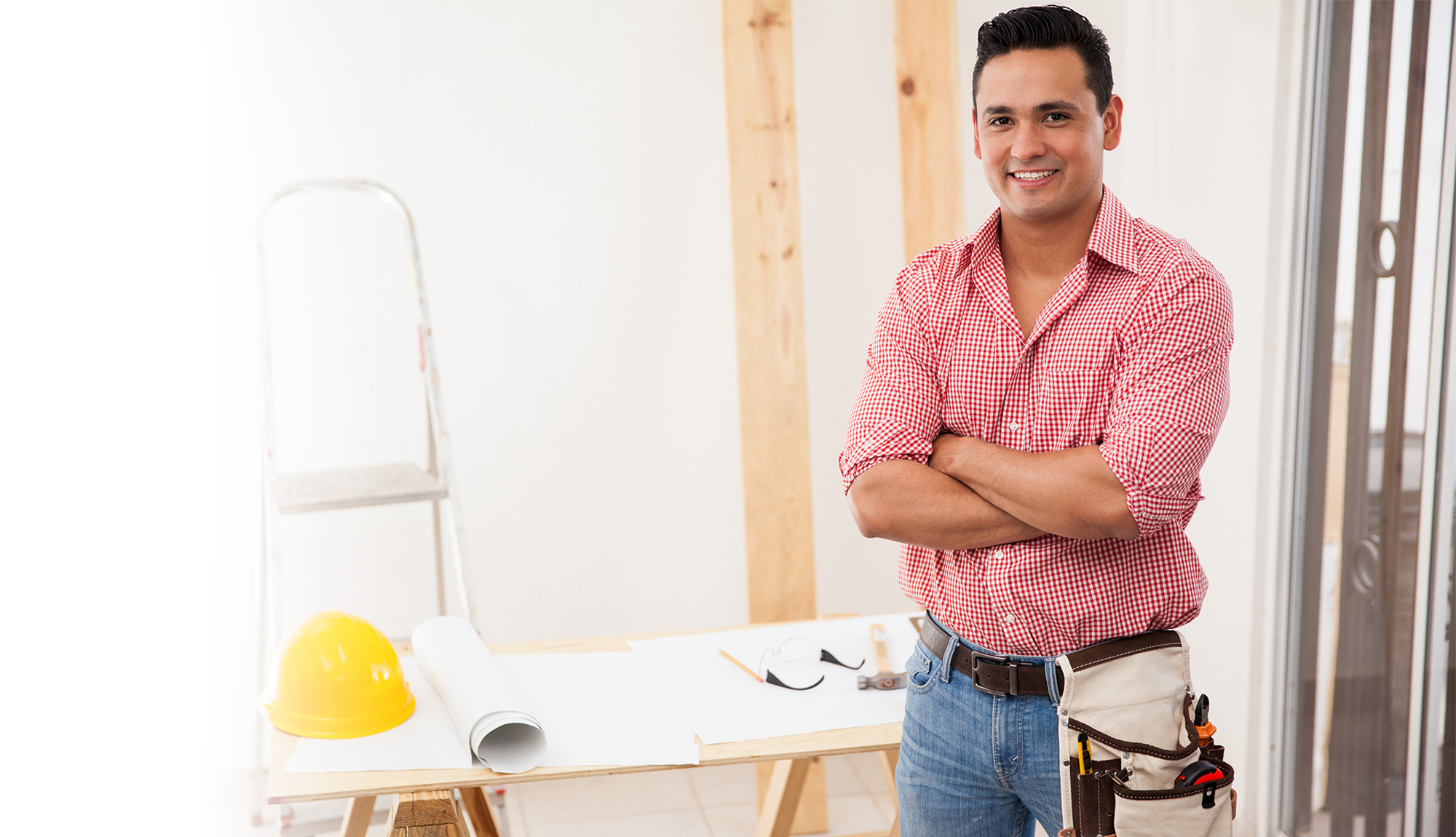 happy contractor wearing tool belt at job site 